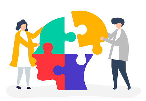 Two people assembling colorful jigsaw puzzle pieces forming a human head, symbolizing collaboration and mental connection
