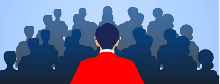 A leader in a red jacket stands before a crowd of silhouetted people, symbolizing Indian leadership.