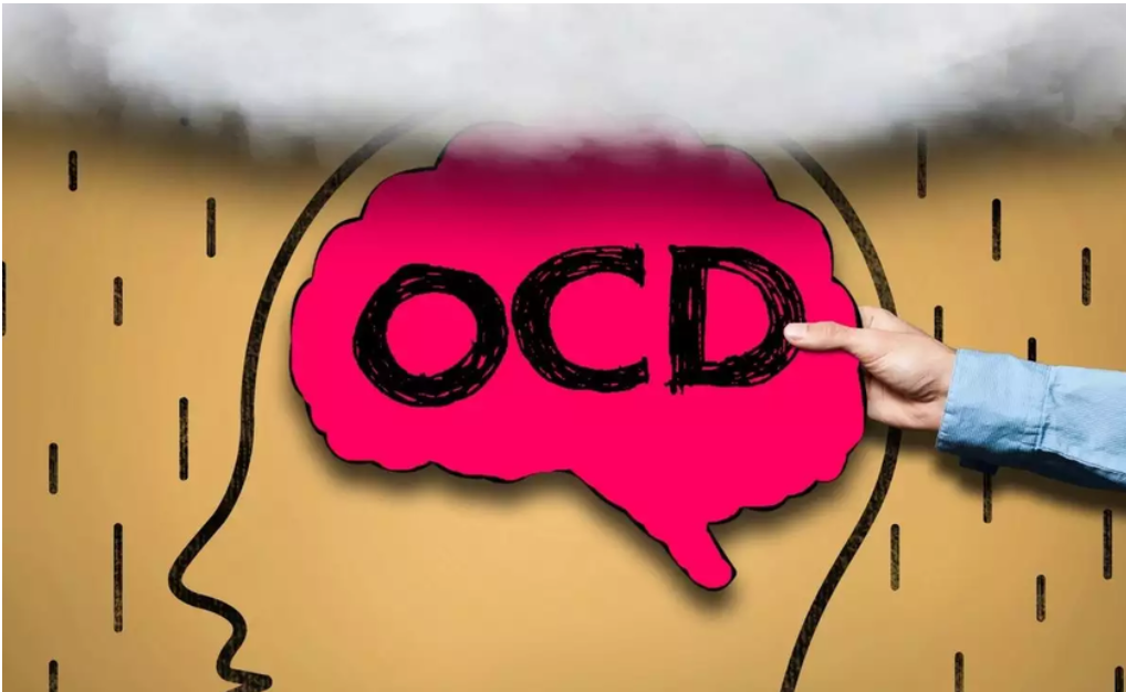Hand pointing to a pink brain shape with OCD written inside, emerging from a head silhouette