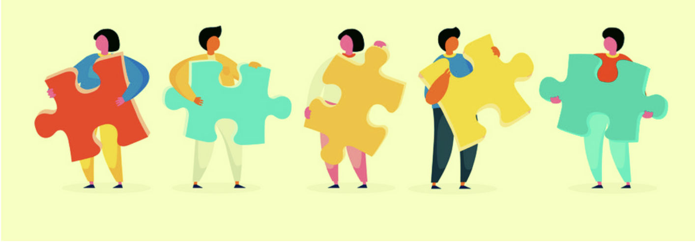 Five diverse people standing in a row, each holding a large colorful puzzle piece, illustrating teamwork and collaboration.