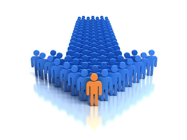 Orange human figure standing in front of a large group of blue figures, symbolizing individual leadership