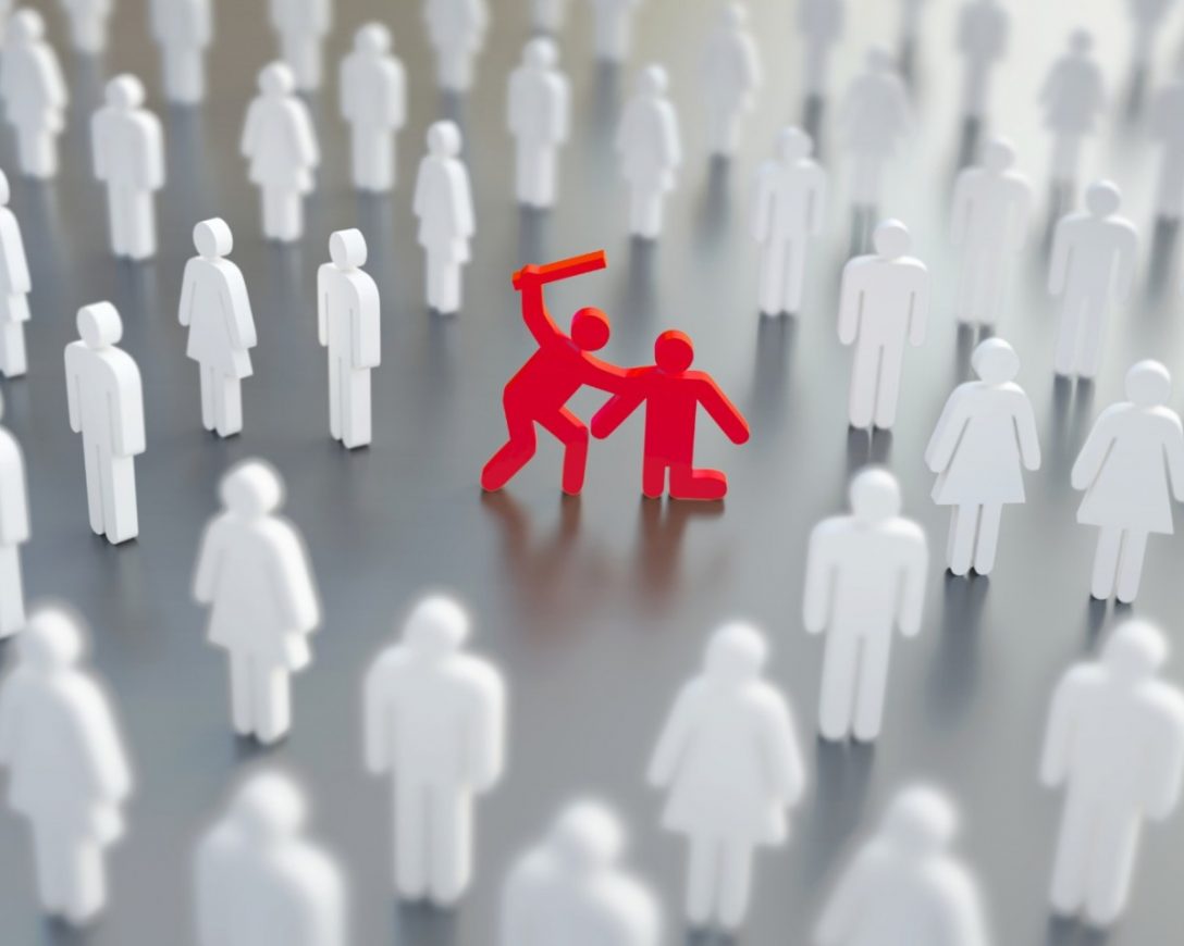 Two red figures, one attacking another with a raised object, surrounded by indifferent white figures in a crowd.