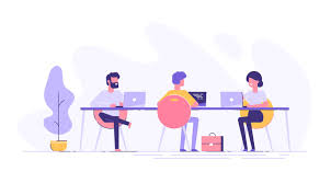 Three people working on laptops at a shared desk in a modern office space with a potted plant.