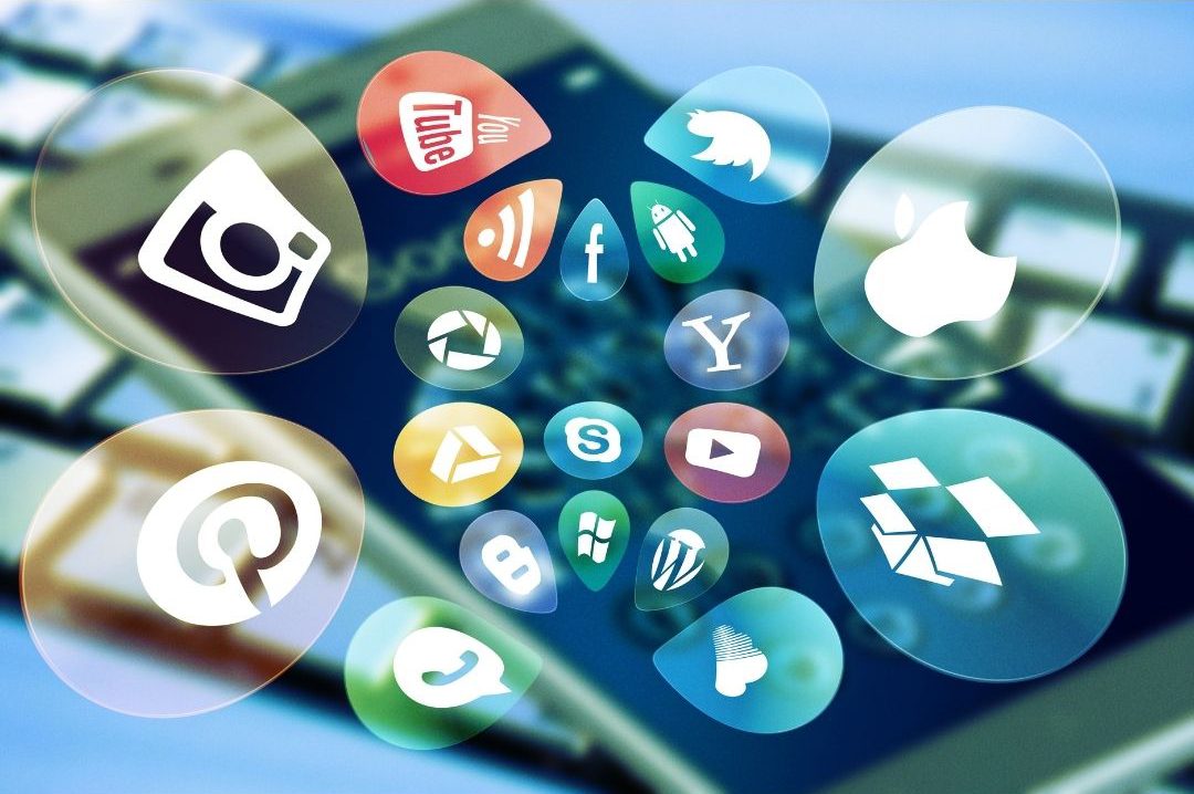 Colorful social media and tech app icons floating over a blurred smartphone screen.